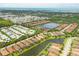 Aerial view of a lakeside community with single Gathering homes, white mobile homes and gorgeous waterfront views at 5596 Cantucci St, Nokomis, FL 34275
