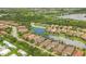 Aerial view of a lakeside community with single Gathering homes, paved driveways, lush landscaping and beautiful views at 5596 Cantucci St, Nokomis, FL 34275