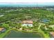 Aerial view of a community featuring lush landscaping, tennis courts, clubhouse, and pool at 5596 Cantucci St, Nokomis, FL 34275