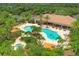 Aerial shot of the community pool and amenity center, showcasing lush landscaping and recreational facilities at 5596 Cantucci St, Nokomis, FL 34275