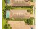 Aerial view of a neighborhood showcasing well-maintained homes, lush landscaping, and a community pool at 5596 Cantucci St, Nokomis, FL 34275