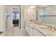 Stylish bathroom featuring dual sinks, granite countertops, and a glass-enclosed shower at 5596 Cantucci St, Nokomis, FL 34275