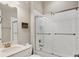 Bathroom featuring a glass shower, toilet and vanity with a sink and a large mirror at 5596 Cantucci St, Nokomis, FL 34275