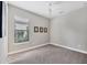 Cozy bedroom with plush carpet, a ceiling fan, and a bright window overlooking the outdoors at 5596 Cantucci St, Nokomis, FL 34275