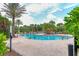 Resort-style community pool surrounded by lush landscaping and lounge chairs, offering a perfect spot for relaxation at 5596 Cantucci St, Nokomis, FL 34275