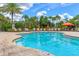 Community pool with ample lounge seating, ideal for relaxation and enjoying sunny days in a tropical atmosphere at 5596 Cantucci St, Nokomis, FL 34275