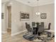 Modern dining room featuring a glass-top table, seating for six, and contemporary decor at 5596 Cantucci St, Nokomis, FL 34275