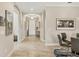 Hallway with tile flooring, arched doorways, and access to the formal dining room at 5596 Cantucci St, Nokomis, FL 34275