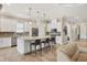 Spacious open kitchen with stainless appliances, stone countertops, pendant lighting, and island seating at 5596 Cantucci St, Nokomis, FL 34275