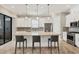 Charming kitchen with stainless appliances, stone countertops, pendant lighting, and island seating at 5596 Cantucci St, Nokomis, FL 34275