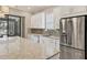 Bright kitchen with stainless steel appliances and stone countertops at 5596 Cantucci St, Nokomis, FL 34275