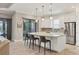 Bright kitchen with stainless steel appliances, bar stool seating, and stone countertops at 5596 Cantucci St, Nokomis, FL 34275