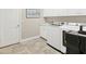 Functional laundry room featuring modern appliances, cabinetry, and tile flooring at 5596 Cantucci St, Nokomis, FL 34275