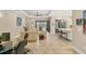 Open-concept living area features tile flooring, neutral paint, recessed lighting, and sliding glass doors at 5596 Cantucci St, Nokomis, FL 34275