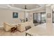 Bright living room with tile flooring, neutral paint, a ceiling fan and a sliding glass doors at 5596 Cantucci St, Nokomis, FL 34275