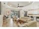Open living area with modern ceiling fan, view of the pool, and an adjacent kitchen with island seating at 5596 Cantucci St, Nokomis, FL 34275