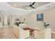 Living room with tile flooring, neutral paint, tray ceiling, ceiling fan and recessed lighting at 5596 Cantucci St, Nokomis, FL 34275