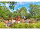 Community outdoor lounge with seating, creating a perfect spot for relaxation and socializing in a lush garden setting at 5596 Cantucci St, Nokomis, FL 34275