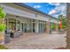 Outdoor patio featuring comfortable seating and dining areas, ideal for enjoying the serene views and weather at 5596 Cantucci St, Nokomis, FL 34275