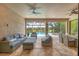 Spacious patio featuring comfortable seating, ceiling fans, and views of the inviting pool and lush landscaping at 5596 Cantucci St, Nokomis, FL 34275