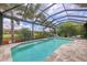 Beautiful pool and screened patio with lush landscaping, perfect for relaxation and outdoor enjoyment at 5596 Cantucci St, Nokomis, FL 34275