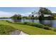 Lush backyard with manicured lawn leading to a serene waterfront view at 719 Estuary Dr # 719, Bradenton, FL 34209