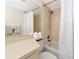 Bathroom featuring shower and tub combo, white tiles, toilet and large mirror with counter at 719 Estuary Dr # 719, Bradenton, FL 34209