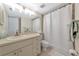 Bathroom featuring a large mirror, vanity with storage, and a shower with white curtain at 719 Estuary Dr # 719, Bradenton, FL 34209