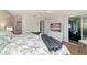 Bedroom featuring TV, tropical bedding, access to bathroom, and sliding glass doors to patio at 719 Estuary Dr # 719, Bradenton, FL 34209