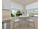 Cozy kitchen breakfast nook bathed in natural light from two windows, complete with seating and a view at 719 Estuary Dr # 719, Bradenton, FL 34209