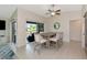 Dining room features dining table, slider to porch and contemporary light fixture at 719 Estuary Dr # 719, Bradenton, FL 34209