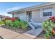 Charming home featuring attractive landscaping, including colorful shrubbery, with a walkway to the front door at 719 Estuary Dr # 719, Bradenton, FL 34209