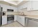 Well-equipped kitchen with stainless steel appliances, white cabinets and tile flooring at 719 Estuary Dr # 719, Bradenton, FL 34209