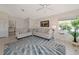 Bright living room features neutral walls, plush sofas, and a stylish blue and gray palm leaf rug at 719 Estuary Dr # 719, Bradenton, FL 34209