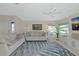 Bright living room features stylish sofas, a ceiling fan, a flat-screen TV, and a decorative area rug at 719 Estuary Dr # 719, Bradenton, FL 34209