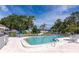 Inviting community swimming pool surrounded by lush greenery and comfortable seating at 719 Estuary Dr # 719, Bradenton, FL 34209