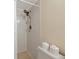 Shower featuring white tiled walls, adjustable shower head, and storage for toiletries at 719 Estuary Dr # 719, Bradenton, FL 34209