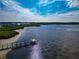 Scenic water view from a pier and lush coastal surroundings, with neighborhood homes in the background at 719 Estuary Dr # 719, Bradenton, FL 34209