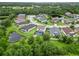 Gorgeous aerial perspective of a community, featuring homes with screened-in pools and pond views at 731 116Th Ne Ct, Bradenton, FL 34212