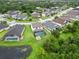 Scenic aerial shot showcasing a home with pool, set in a vibrant neighborhood near a pond at 731 116Th Ne Ct, Bradenton, FL 34212