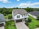 Aerial view of a landscaped property with a lush green lawn, complemented by a paver driveway at 731 116Th Ne Ct, Bradenton, FL 34212