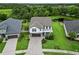 Aerial view of a landscaped property with a lush green lawn, complemented by a tranquil pond at 731 116Th Ne Ct, Bradenton, FL 34212