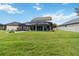 Green and well-manicured backyard features a screened-in pool area. Perfect for outdoor gatherings at 731 116Th Ne Ct, Bradenton, FL 34212