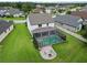 Stunning backyard featuring a screened-in pool, outdoor seating area, and pristine landscaping at 731 116Th Ne Ct, Bradenton, FL 34212