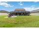 Spacious backyard featuring a screened-in pool area, a brick firepit and plenty of green space at 731 116Th Ne Ct, Bradenton, FL 34212
