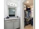 Bathroom featuring a full vanity and a walk-in closet for storage at 731 116Th Ne Ct, Bradenton, FL 34212