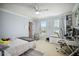 Bright bedroom with neutral walls, a ceiling fan, two windows, and furniture at 731 116Th Ne Ct, Bradenton, FL 34212
