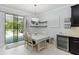 Cozy dining area with sliding glass doors to patio and a sleek wine cooler at 731 116Th Ne Ct, Bradenton, FL 34212