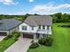 Charming two-story home with manicured lawn, complemented by a paver driveway and lush landscaping at 731 116Th Ne Ct, Bradenton, FL 34212