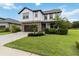Attractive two-story house with stone accents, a brown garage door, and lush green landscaping at 731 116Th Ne Ct, Bradenton, FL 34212